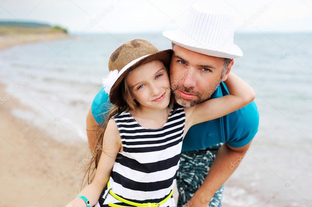 Happy father and his daughter at beach
