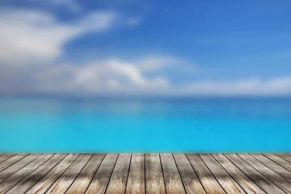 Wood table top with blurred blue sea, used for display or montag — Stock Photo, Image