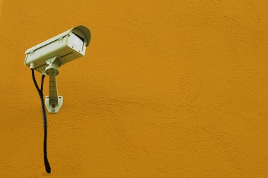 CCTV camera or surveillance installed on wall clipart