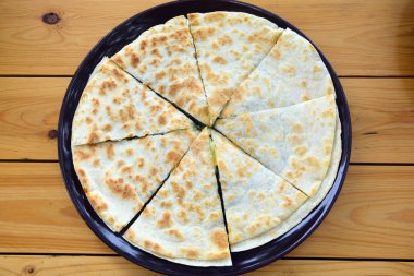 Bir masanın üzerine yerleştirilen bir tavada ıspanaklı tortilla