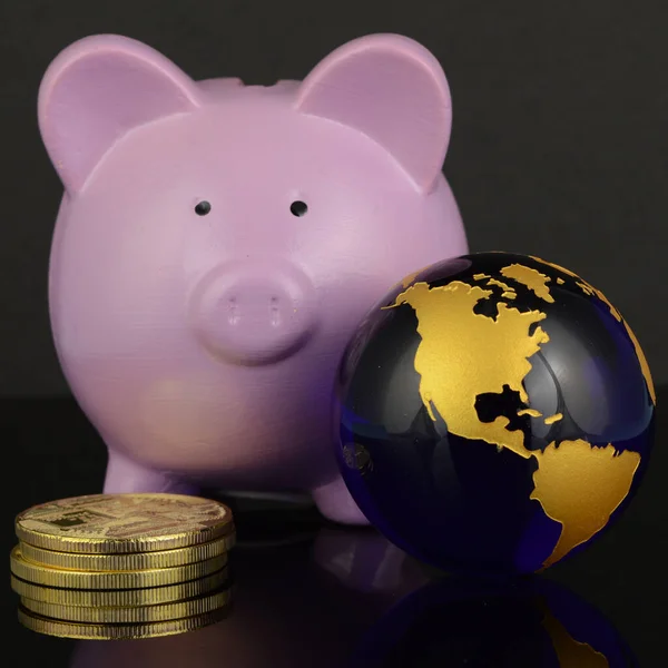 A global money concept with a pig bank and globe of the Earth.