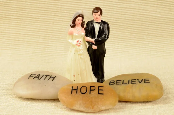 結婚式の日を祝福するためのいくつかの石の肯定の言葉を持つ夫婦ケーキのトッパー — ストック写真