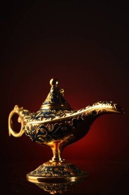 Atmosferik kırmızı ve siyah bir arkaplan üzerinde büyülü bir pirinç yağ lambası..