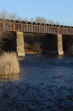 Ontario 'daki küçük bir kasaba olan Smiths Falls' taki Rideau Kanalı 'nın taze su yolundan geçen bir tren köprüsü..