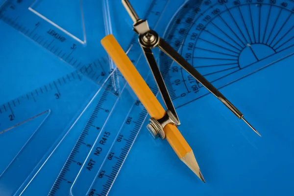 A math set consisting a compass and protractor and rulers and angles.