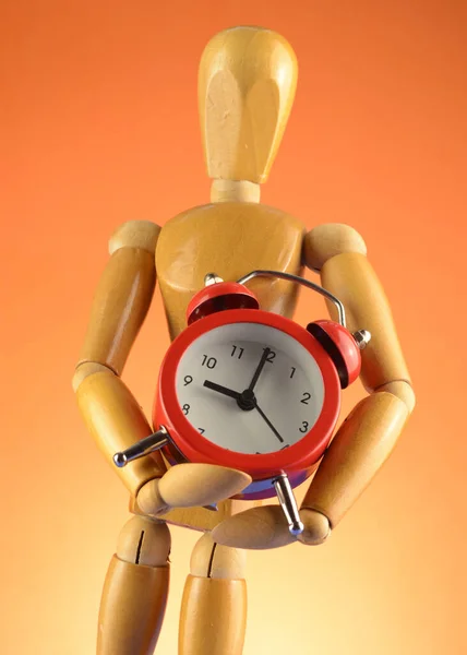 Artists Wooden Dummy Mannequin Holds Red Alarm Clock Orange Background — Stock Photo, Image