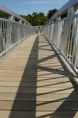 A closeup of a walking bridge during the sunlight to showcase all the lines of interest.