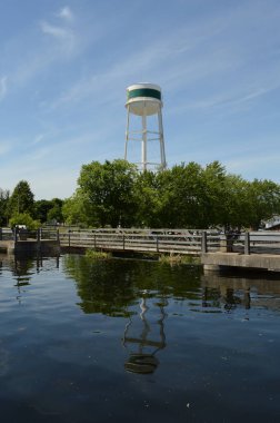 A tall white water tower located in Smiths Falls, Ontario on the Rideau Canal.