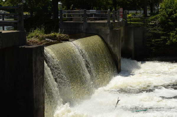 SMITHS FALLS, ONTARIO, CA, JUNE 12, 2021: The reservoir dam located in Smiths Falls, Ontario showing its flowing currents of water.