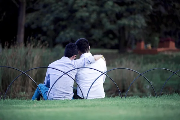 Beautiful gay couple relaxing in the park — Stock Photo, Image