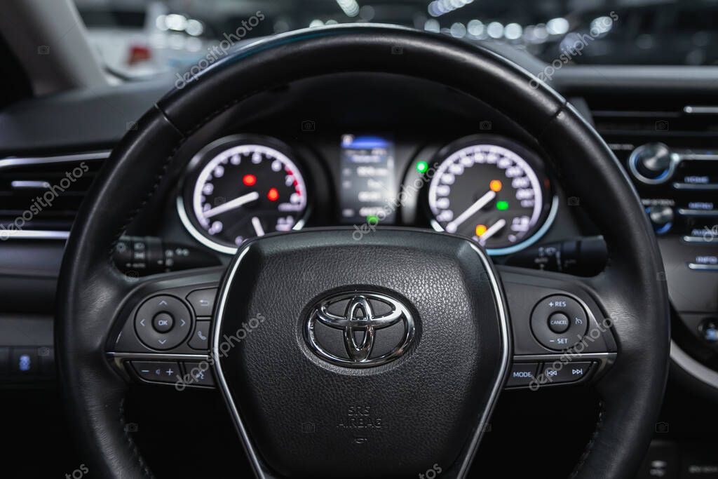 Novosibirsk, Russia  October 22, 2020:  Toyota Camry, Auto interior: steering wheel with  logo    and  speedometer and tachometer