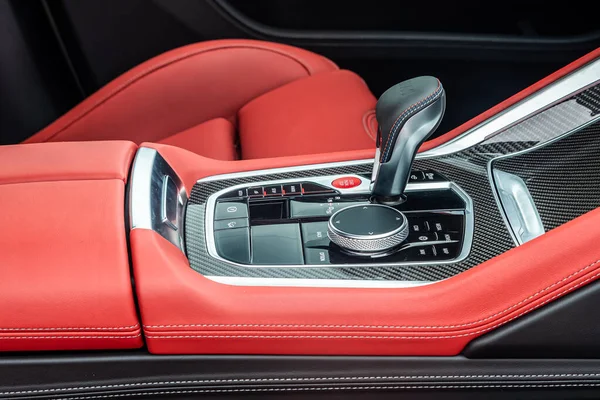 Close-up view of the automatic gearbox lever. Red expensive leather interior car,  automatic transmission gearshift stick;