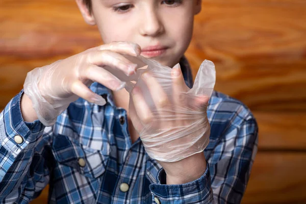 Close Little Boy Himself Tries Put Disposable Medical Gloves Nothing — Fotografia de Stock