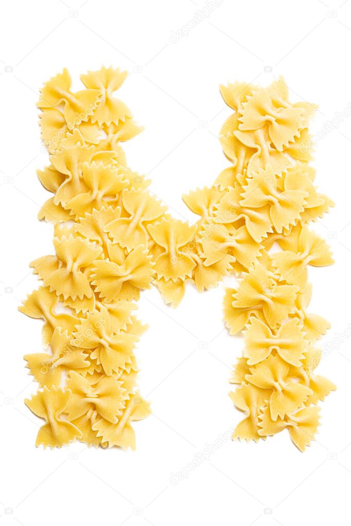Letter H of the English alphabet from dry farfalle pasta on a white isolated background. Food pattern made from macaroni. Bright alphabet for shops. 