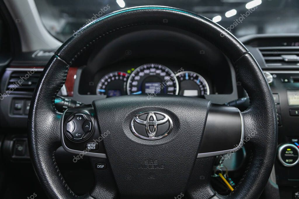 Novosibirsk, Russia  February 07 2021: Toyota Camry, Auto interior: steering wheel with logo and buttons, speedometer and tachometer