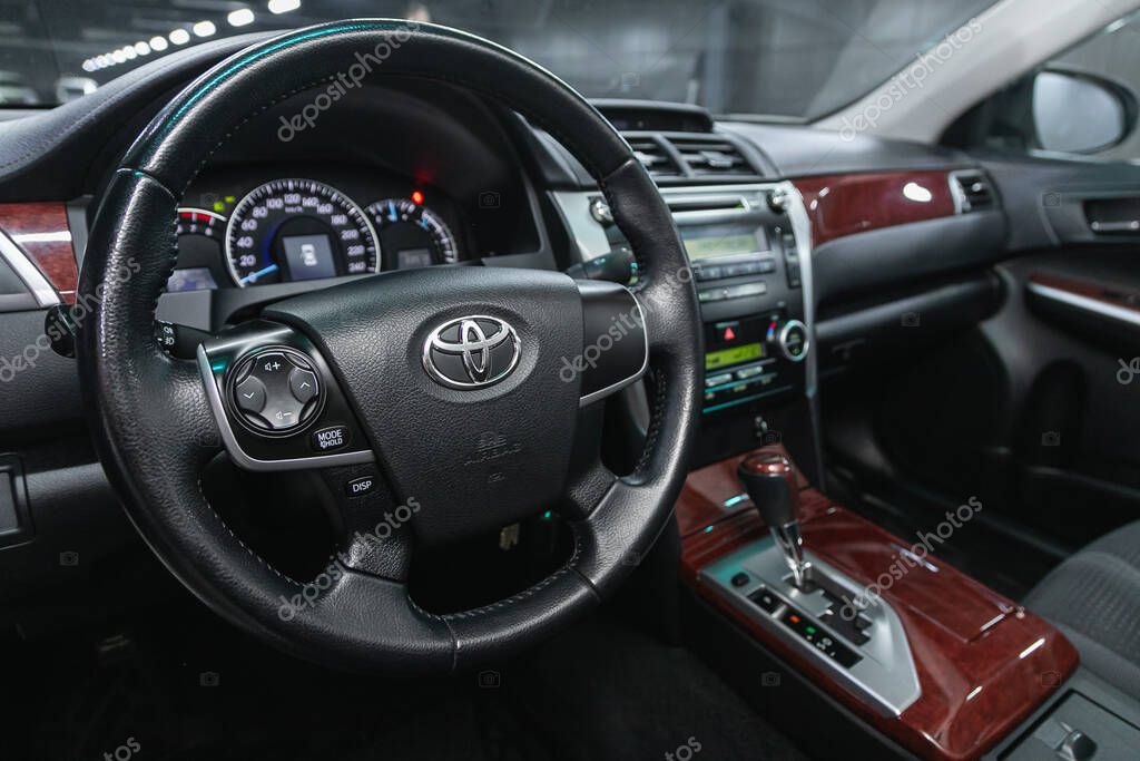 Novosibirsk, Russia  February 07 2021: Toyota Camry, Auto interior: steering wheel with logo and buttons, speedometer and tachometer