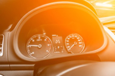 Benzin deposunda entegre yakıt göstergesi olan, sarı ve turuncu neon kolonun altında beyaz okları olan modern bir arabanın hız göstergesi.