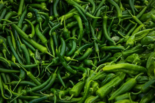 Close-up green vegetable for background, green pepper texture. Green chili peppers form a natural shape. Fresh raw vegetables