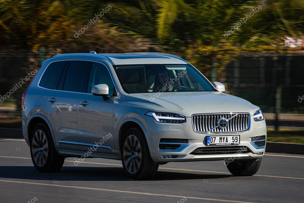 Alanya, Turkey  April 18 2021:  white Volvo XC90 is driving fast on the street on a warm summer day against the backdrop of a  palms