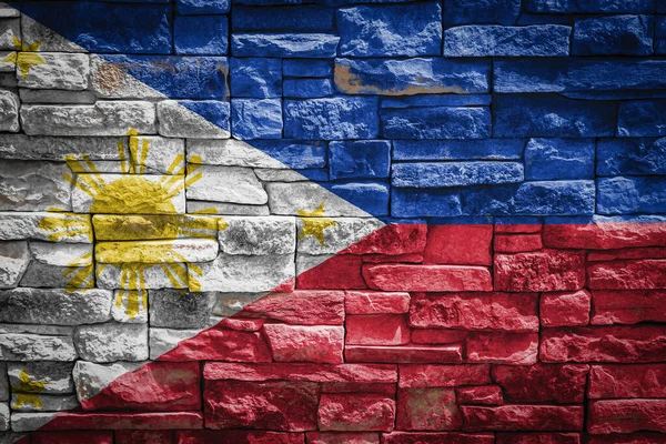 石の壁の背景にフィリピンの国旗 国家の誇りと国のシンボルの概念 石の質感の背景に旗 — ストック写真