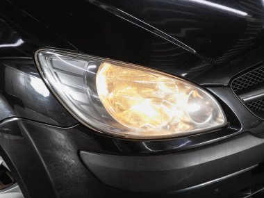 Novosibirsk, Russia - June 08, 2021: Hyundai Getz  ,  Close up of the car headlights. Exterior closeup detail. clipart