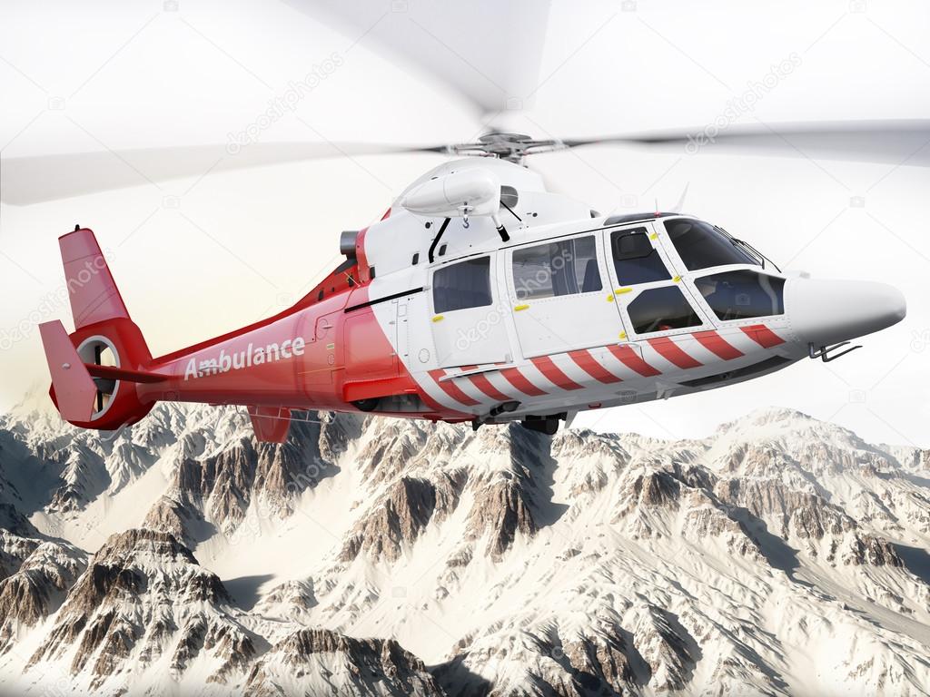 Rescue helicopter in flight over snow capped mountains with motion blur blades.