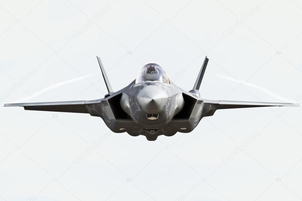 F35 front view close up flying to the camera with chem trails Stock