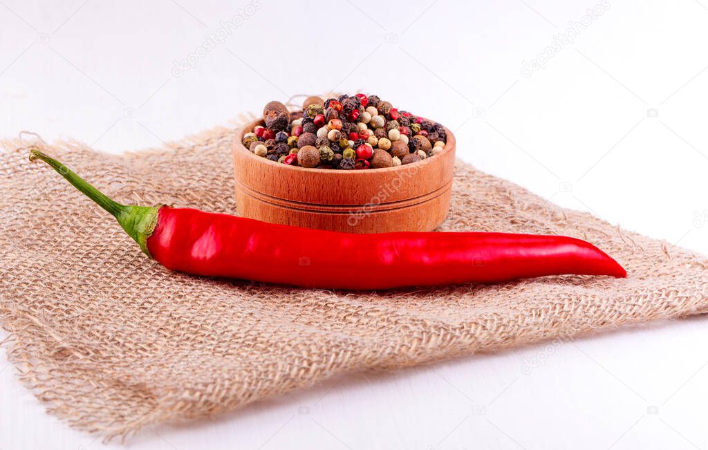 red chili pepper and burlap on white wooden table