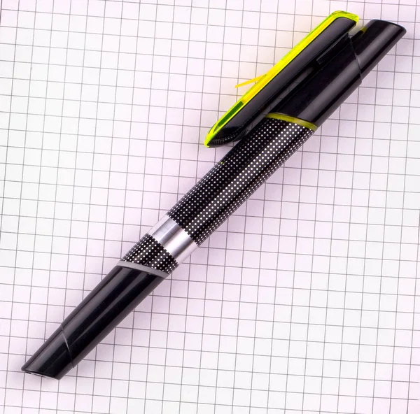 black pen for writing on white checkered notebook paper
