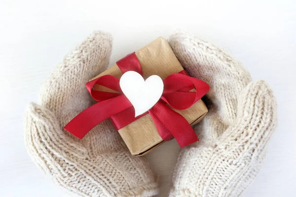Hands White Knitted Mittens Hold Gift Red Bow Decorated Heart — Stock Photo, Image