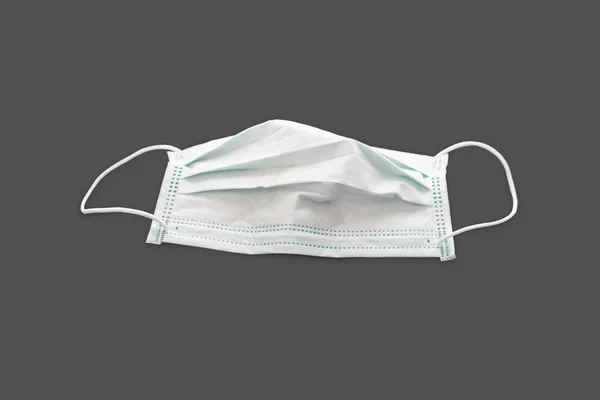 Surgical mask with rubber ear straps isolated on white with clipping path. White mask to cover the mouth and nose. Procedure mask from bacteria.