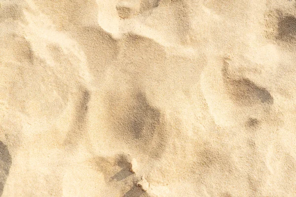 Sand texture background on the beach. Light beige sea sand texture pattern, sandy beach background.