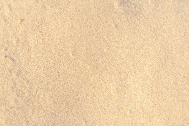 Sahildeki kum dokusu. Açık bej rengi deniz kumu deseni, kumlu plaj arkaplanı..
