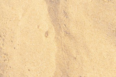 Kumsalda kum dokusu. Arka plan için kahverengi kumsal. Yakın plan..