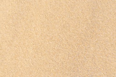 Kum dokusu geçmişi. Tropikal kumsaldan gelen kahverengi çöl deseni. Yakın plan..
