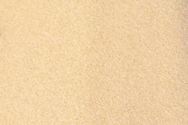 Kum dokusu geçmişi. Tropikal kumsaldan gelen kahverengi çöl deseni. Yakın plan..