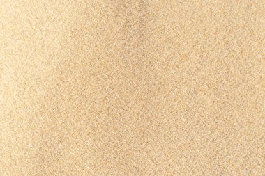 Kum dokusu geçmişi. Tropikal kumsaldan gelen kahverengi çöl deseni. Yakın plan..