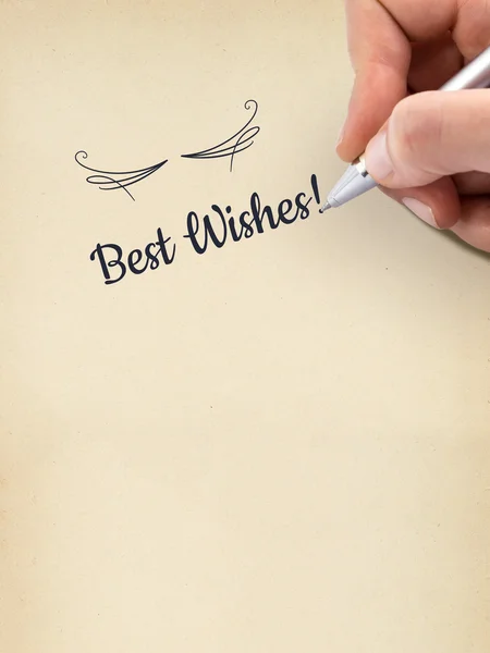 Hand writing "Best Wishes!" on aged sheet of paper. — Stock Photo, Image