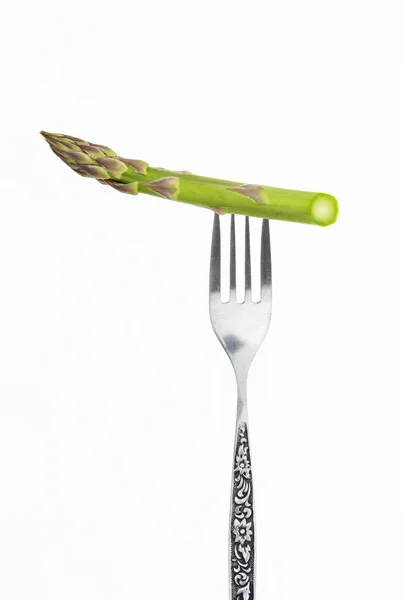Asparagus spear on fork closeup, isolated on white background. — Stock Photo, Image