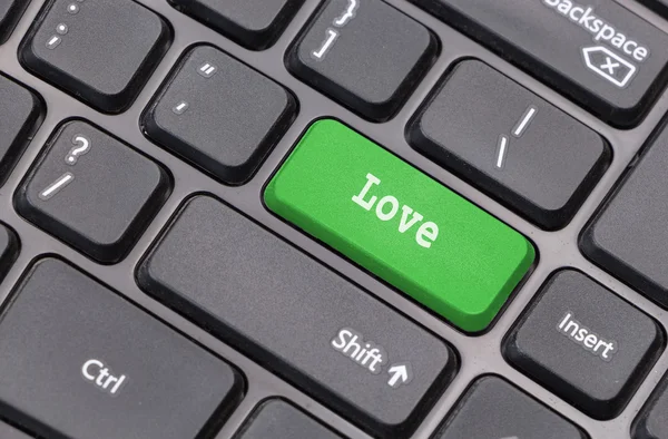 Computer keyboard closeup with "Love" text on green enter key — Stock Photo, Image