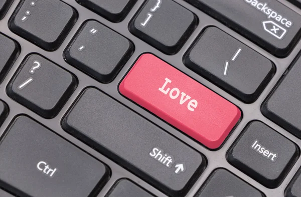 Computer keyboard closeup with "Love" text on red  enter key — Stock Photo, Image