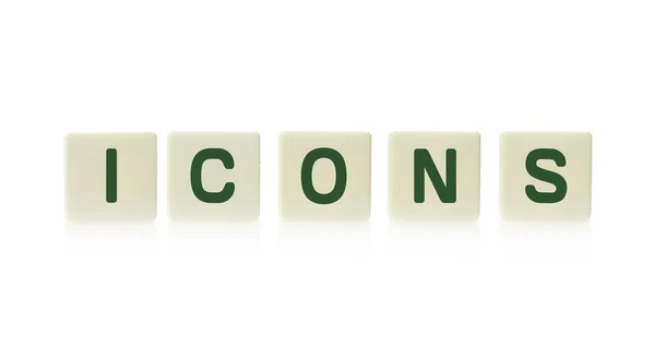 Word "Icons" on board game square plastic tile pieces, isolated on a white background. — Stock Photo, Image