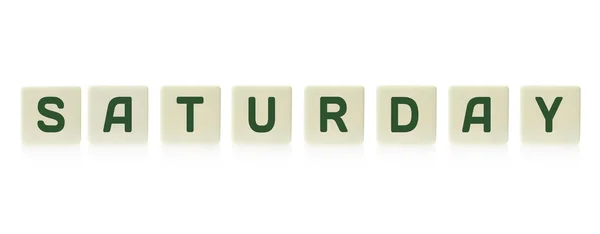 Word "Saturday" on board game square plastic tile pieces, isolated on a white background. — Stock Photo, Image