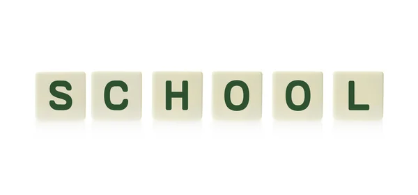 Word "School" on board game square plastic tile pieces, isolated on a white background. — Stock Photo, Image