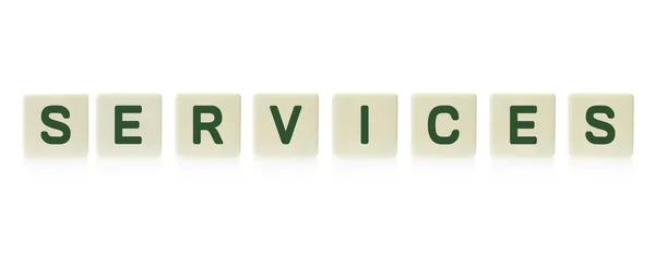 Word "Services" on board game square plastic tile pieces, isolated on a white background. — Stock Photo, Image