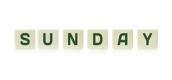 Word "Sunday" on board game square plastic tile pieces, isolated on a white background. — Stock Photo, Image