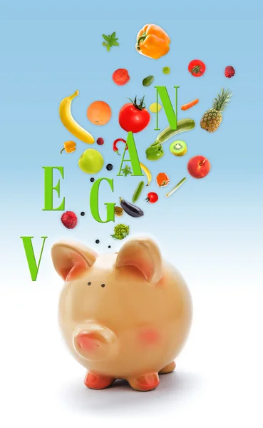 Banco porquinho com frutas e legumes — Fotografia de Stock