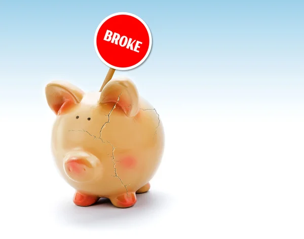 Broken piggy bank with cracks and "Broke" tag — Stock Photo, Image