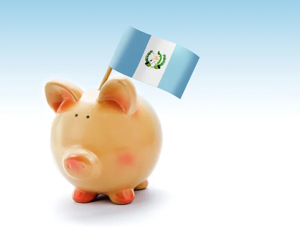 Банк свиней с национальным флагом Гватемалы — стоковое фото