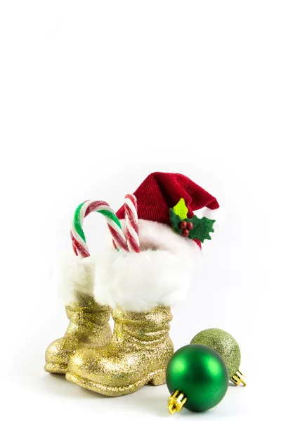 Santas golden boots and red hat with Christmas balls isolated — Stock Photo, Image